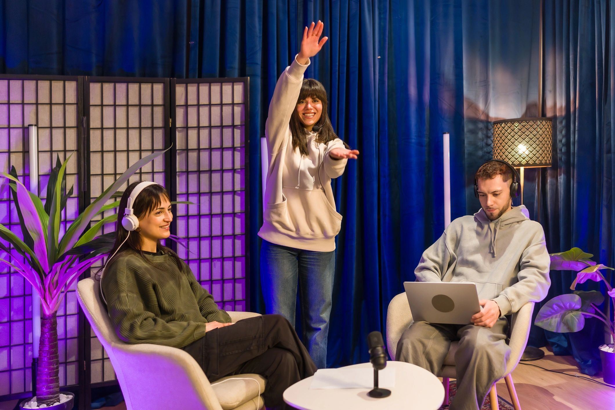 Young adults creating social media content in podcast studio